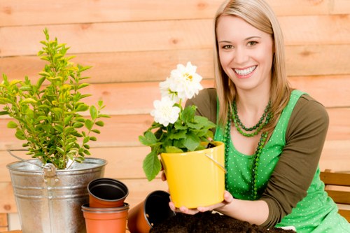 Professional maintaining a landscape garden in Parsons Green.